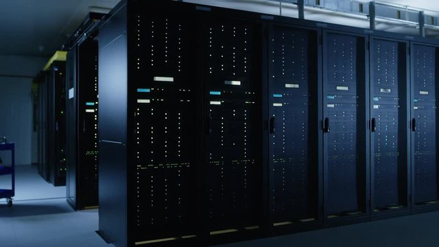 Descending Shot of Data Center With Multiple Rows of Fully Operational Server Racks. Modern Telecommunications, Cloud Computing, Artificial Intelligence, Database, Super Computer Technology Concept.