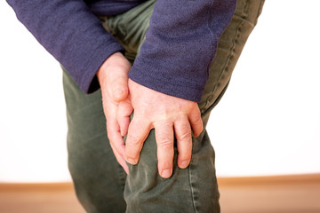 Person holds the aching knee
