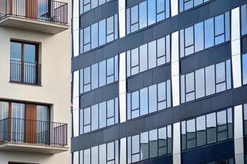 Modern building with reflected sky and cloud in glass window