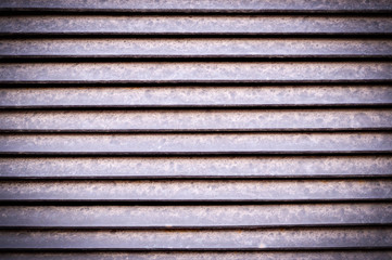 horizontal stripes of dusty metal jalousie exterior with vignette. background, texture.