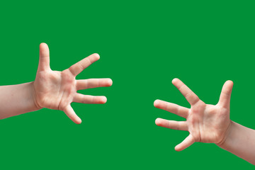 Children's hand shows a sign. Isolated on green background