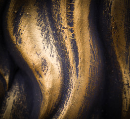 polished wavy bronze texture with vignette. background, concept