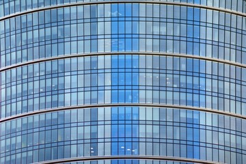 Modern building with reflected sky and cloud in glass window
