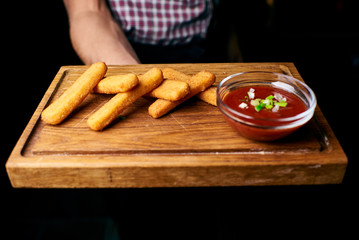 Appetizing dish on a white plate in the hands of the girl waiter, food, snack