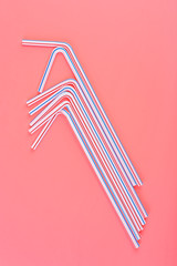 Drinking straws on pink background. Cocktail party concept.
