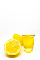 A Mexican tequila shot with lemon on a white isolated background