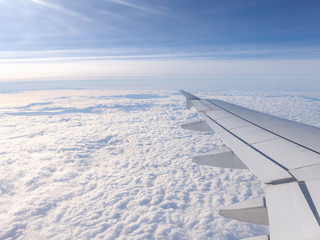 Fototapeta premium Unending clouds under the wing of airplane