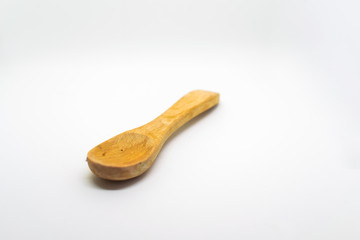 Small light wooden spoon on a white isolated background with blank space for text
