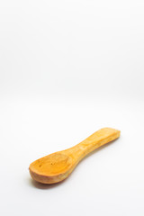 Small light wooden spoon on a white isolated background with blank space for text