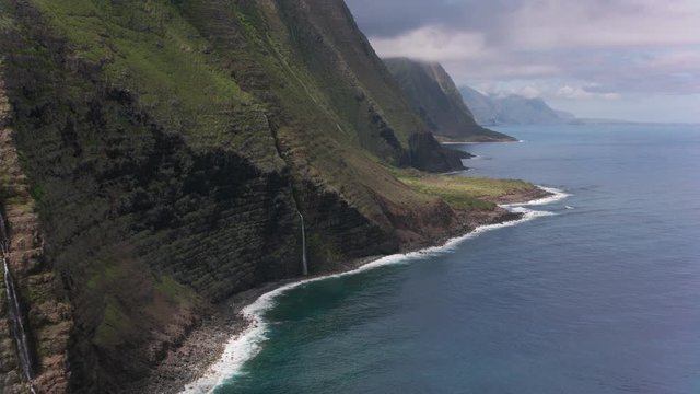 Molokai, Hawaii circa-2018.  Aerial view of Molokai coast with beautiful waterfalls.  Shot with Cineflex and RED Epic-W Helium. 