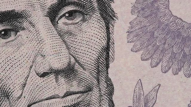 US President Abraham Abe Lincoln on United States 5 dollar bill rotating, five USD. Full HD stock video footage