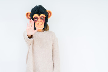 Obraz premium Middle age woman wearing funny and crazy money mask over isolated background with open hand doing stop sign with serious and confident expression, defense gesture