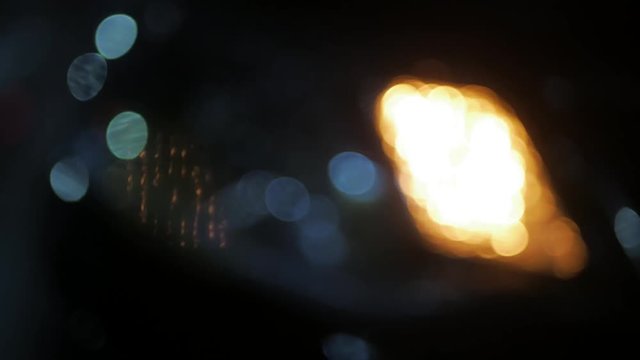 Emergency car warning light on the background of moving cars on a night road city. Winter road traffic cars breakdown outdoors.