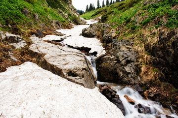 Last snow in the summer mountains. Kazakhstan, Central Asia.