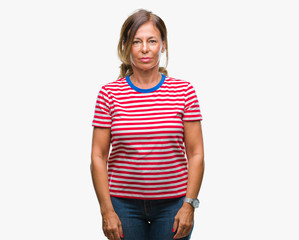 Fototapeta premium Middle age senior hispanic woman over isolated background with serious expression on face. Simple and natural looking at the camera.
