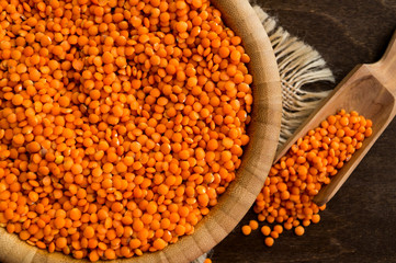 Red dry lentils in a bamboo bowl.