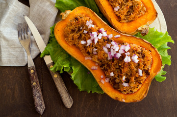 Stuffed baked pumpkin. close-up on a wooden table.