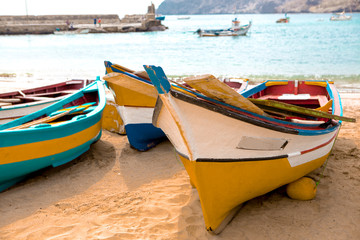 Old fishing pubes on the beach. Colorful boats on the beach of Cape Verde.