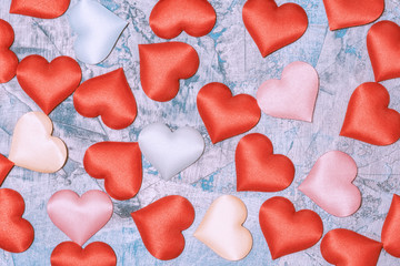 Cloth hearts scattered on the table. Abstract Valentine day background.