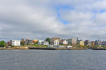 Fototapeta na wymiar Gloucester city skyline from inner harbor, Massachusetts, USA. Gloucester is the largest city of Cape Ann.