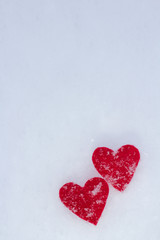 red hearts are powdered with fluffy snow