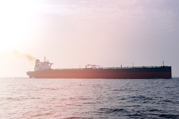 Fototapeta premium Oil tanker at sea, lit by the sun. Transatlantic transportation.
