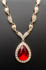 golden pendant with ruby and diamonds isolated on black macro - 243570448