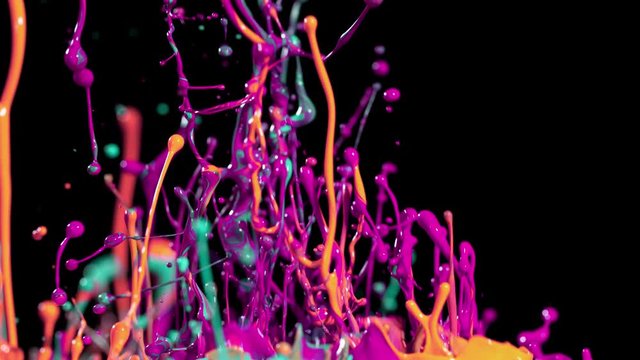Super slow motion of dancing colours shapes isolated on black background.