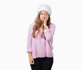 Young beautiful brunette woman wearing sweater and winter hat over isolated background thinking looking tired and bored with depression problems with crossed arms.