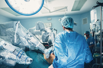 Minimal invasive robot surgical system in hospital. Robotic technology equipment, machine arm...