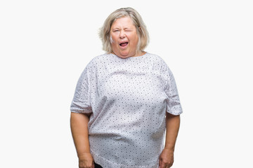 Senior plus size caucasian woman over isolated background winking looking at the camera with sexy expression, cheerful and happy face.