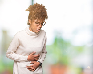 Beautiful young african american woman wearing glasses over isolated background with hand on stomach because indigestion, painful illness feeling unwell. Ache concept.