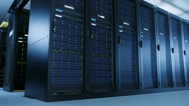 Low Angle Moving Shot of Data Center With Multiple Rows of Fully Operational Server Racks. Modern Telecommunications, Cloud Computing Artificial Intelligence Database, Supercomputer Technology Concept