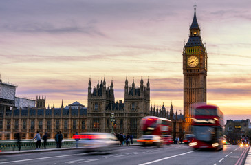 Fototapeta na wymiar London, the UK. Red bus in motion and Big Ben, the Palace of Westminster. The icons of England