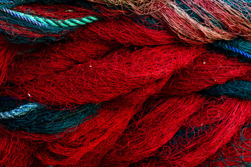 Fishing nets. Background with blue and red ropes.