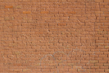 Rust color antique clay brick wall background showing deterioration from age and weather