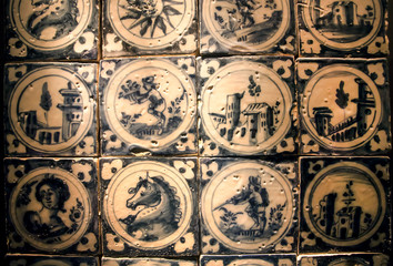 Patterned blue and white ceramic tiles with traditional pictures of life , made in 18th century