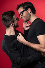 Sexy young gay couple in love, embracing and hugging each other