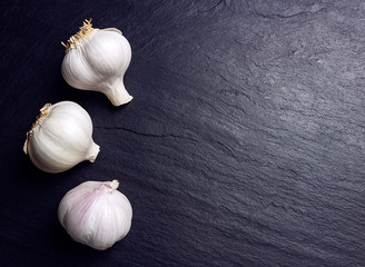 TRES AJOS BLANCOS SOBRE FONDO OSCURO