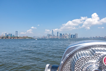binoculars on the edge of Liberty Island, New York City. View of Manhattan from the Statue of Liberty