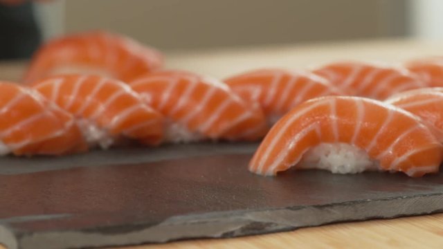Chef places sushi onto tray