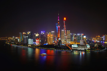 Fototapeta na wymiar A night view of the modern Pudong skyline across the Bund in Shanghai, China
