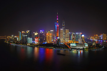 A night view of the modern Pudong skyline across the Bund in Shanghai, China - obrazy, fototapety, plakaty