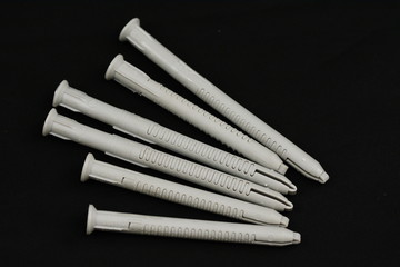  Plastic dowels pin isolated on a black  background