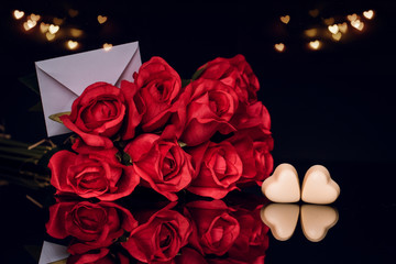 Red roses and heart shaped chocolates, background