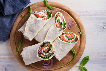Salmon and cream cheese wraps. Wraps with salmon. Homemade tasty burrito. View from above, top...