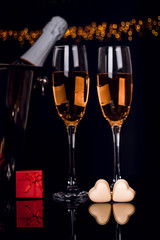 Champagne bottle, wine glasses and chocolates heart