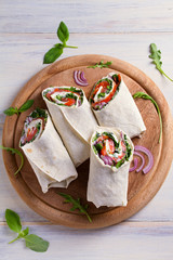 Salmon and cream cheese wraps. Wraps with salmon. Homemade tasty burrito. View from above, top...