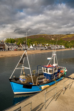 City Of Ullapool With Old Fishing Boat At Loch Broom In Scotland