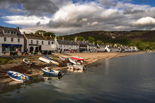 City Of Ullapool With Old Fishing Boat At Loch Broom In Scotland